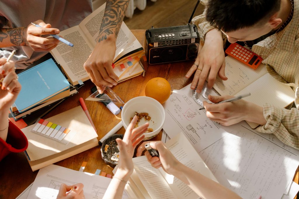 Aerial view of young people doing a project on a tablle