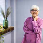 Older woman standing by the windows - Landlady