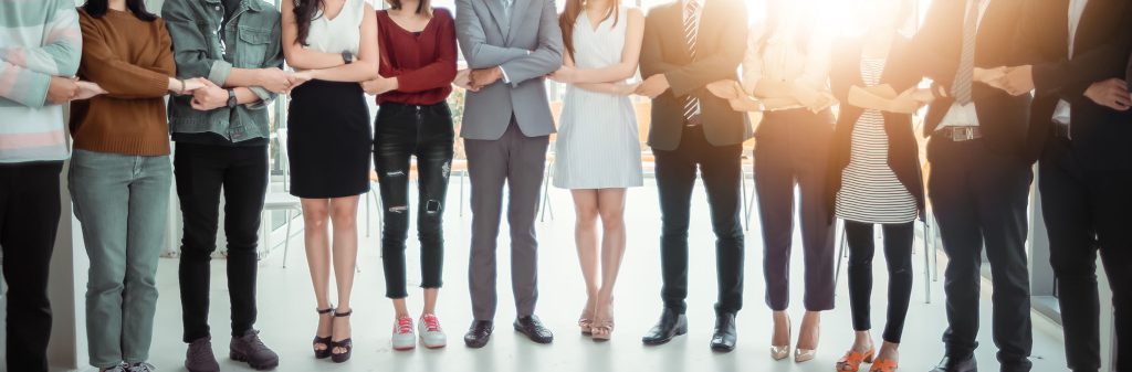 group of people standing holding hands