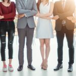 group of people standing holding hands